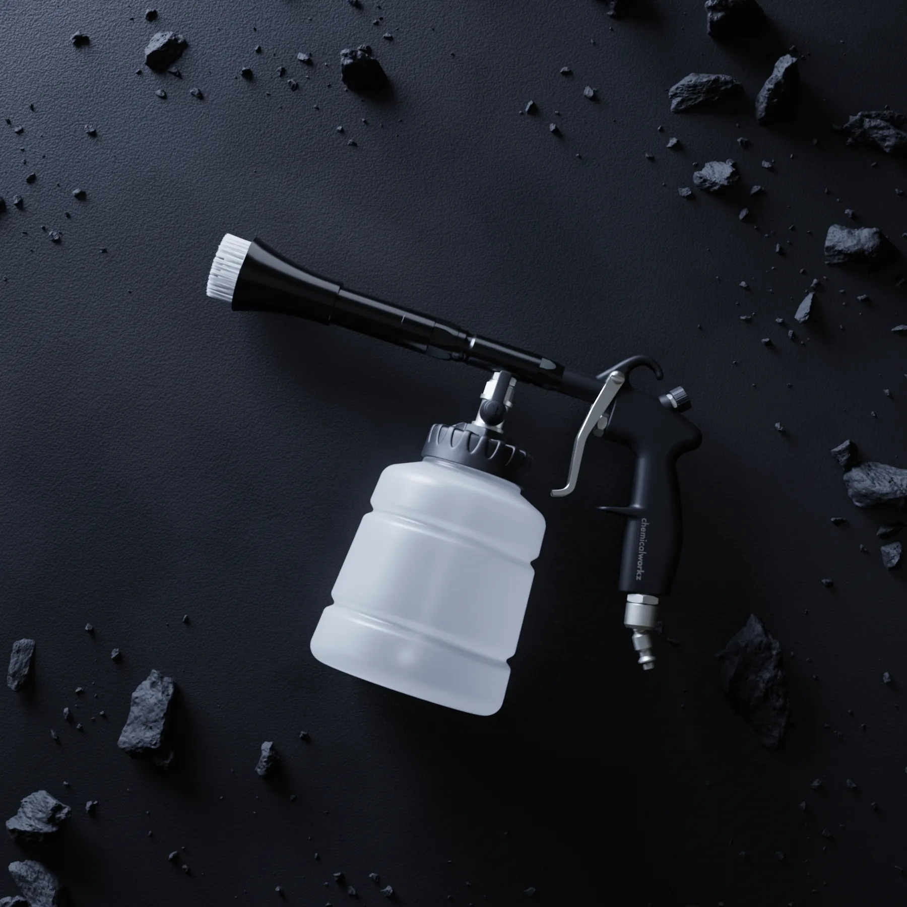 Cleaning gun on dark stone with scattered fragments