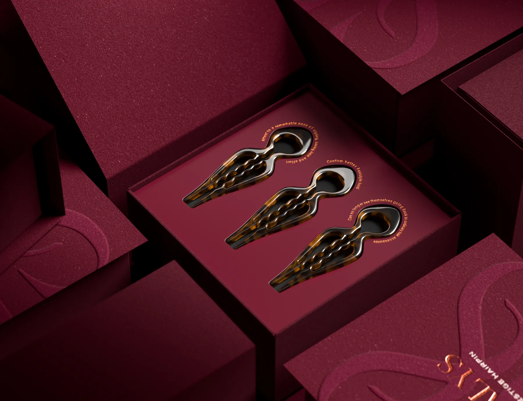 Open LiaLys box with three hairpins set into a shaped burgundy insert